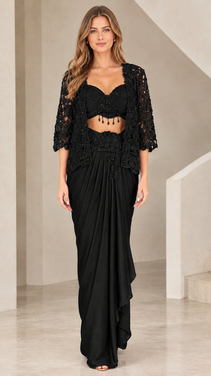 Front view of woman wearing Black 3-piece beaded bustier and draped skirt set