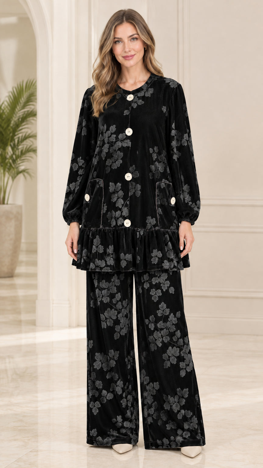 Front view of model wearing black floral embossed velvet tunic top and pants set