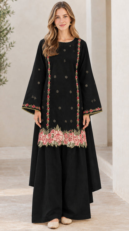 Front view of woman wearing black floral embroidered tunic and wide-leg pants set