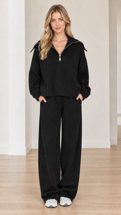 Model wearing black half-zip sailor collar sweatshirt and wide-leg pants matching set