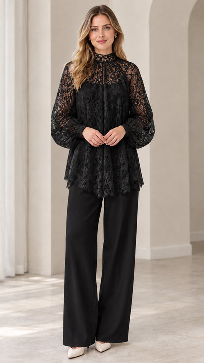 Full look of woman wearing black high neck floral lace blouse and matching black wide leg pants