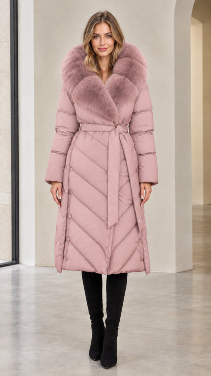 Full-length view of woman in dusty pink belted long winter puffer coat with matching fur trim