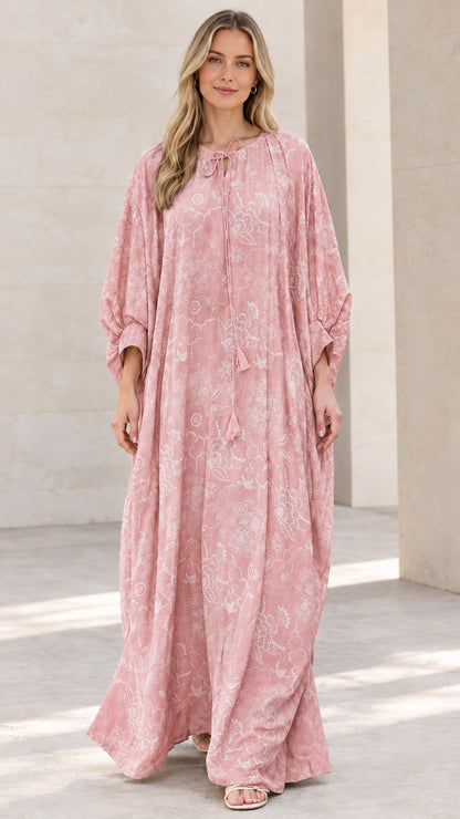 Front view of woman wearing dusty pink floral print caftan maxi dress