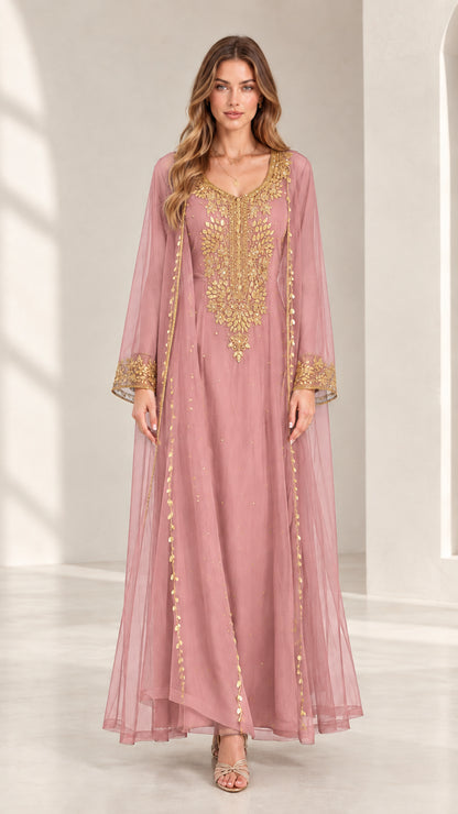 Front view of woman wearing dusty rose embroidered kaftan maxi dress with gold accents