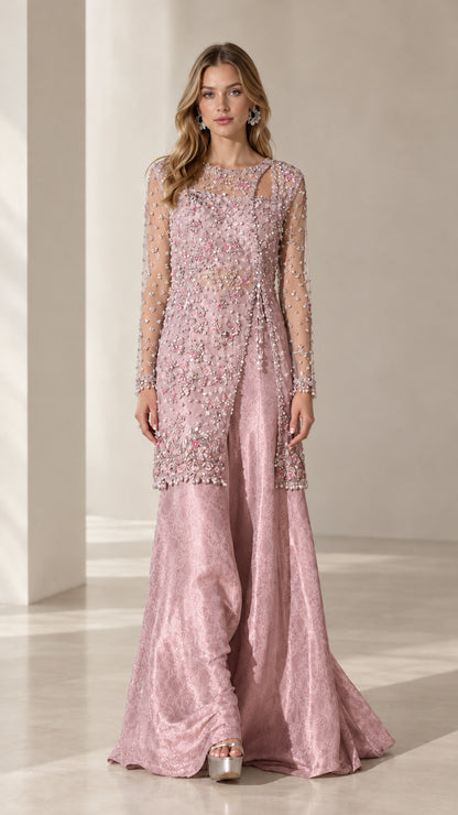 Model wearing dusty pink beaded asymmetric tunic and wide-leg evening trousers