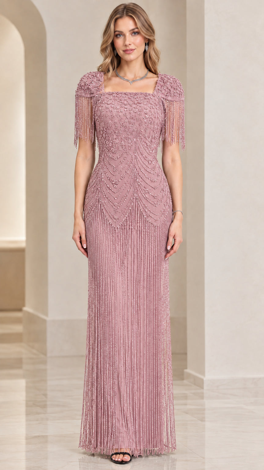 Front view of dusty pink beaded evening gown with cascading fringe