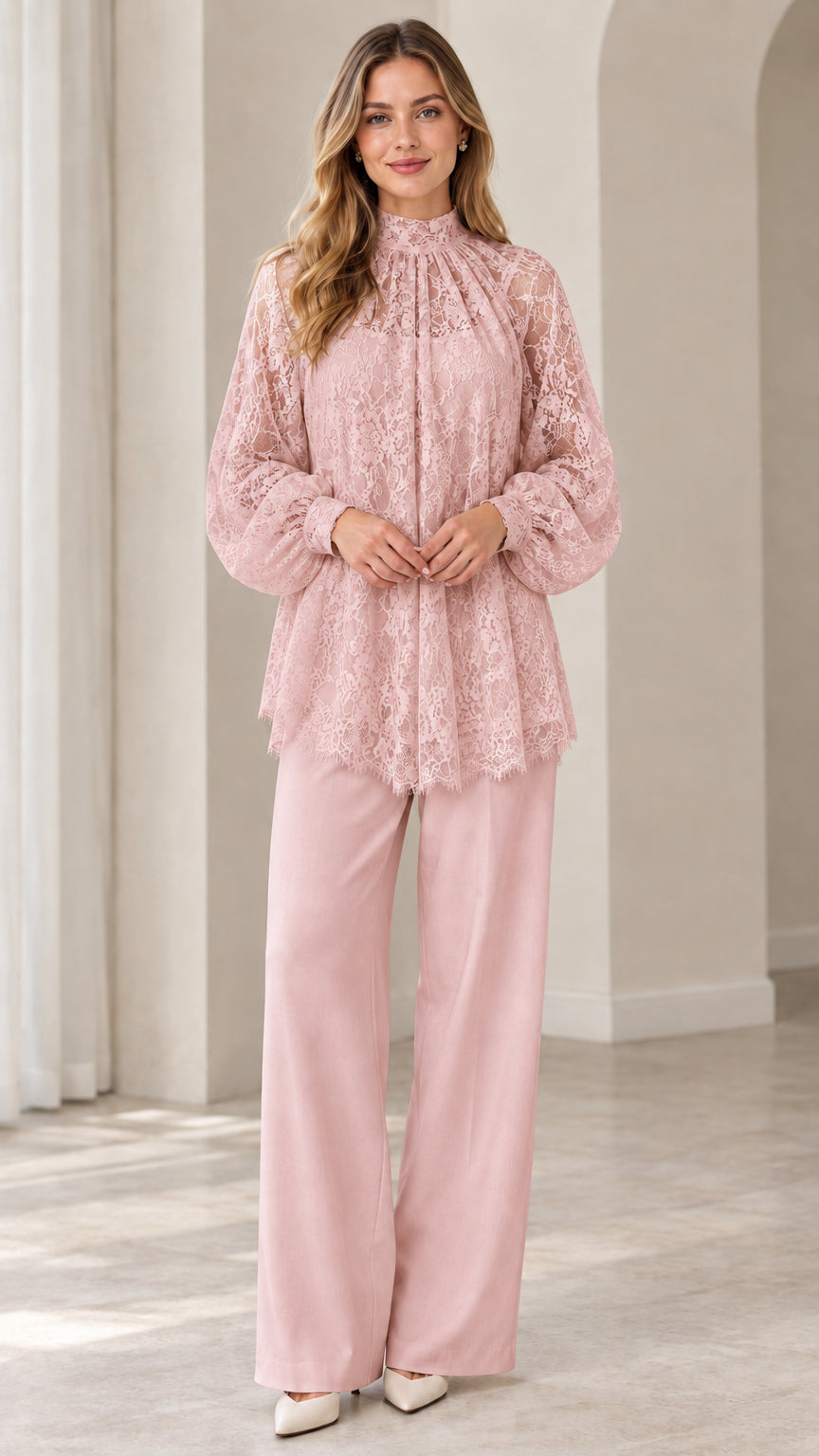 Full look of woman wearing blush pink high neck floral lace blouse and matching pink wide leg pants