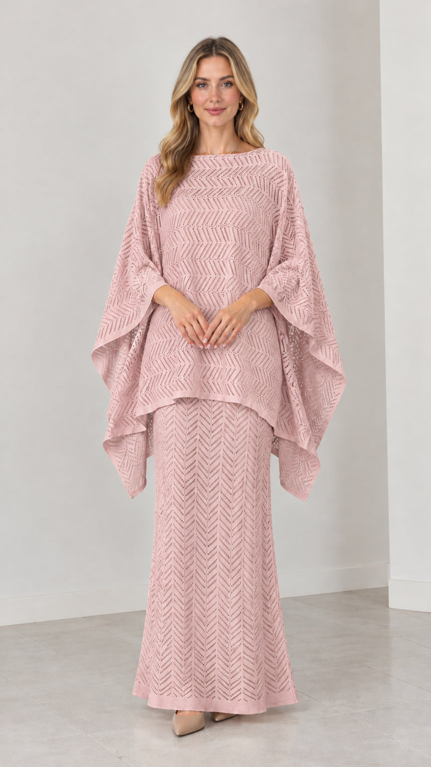 Front view of model wearing dusty pink pointelle knit cape top and maxi skirt set