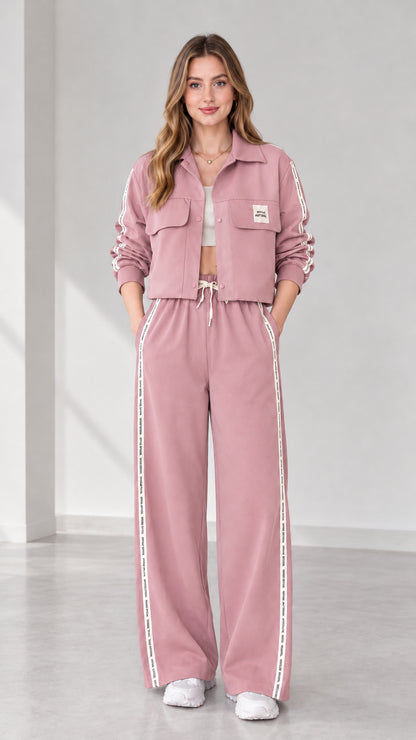 Full view of women's cropped jacket and wide-leg track pants set in dusty pink