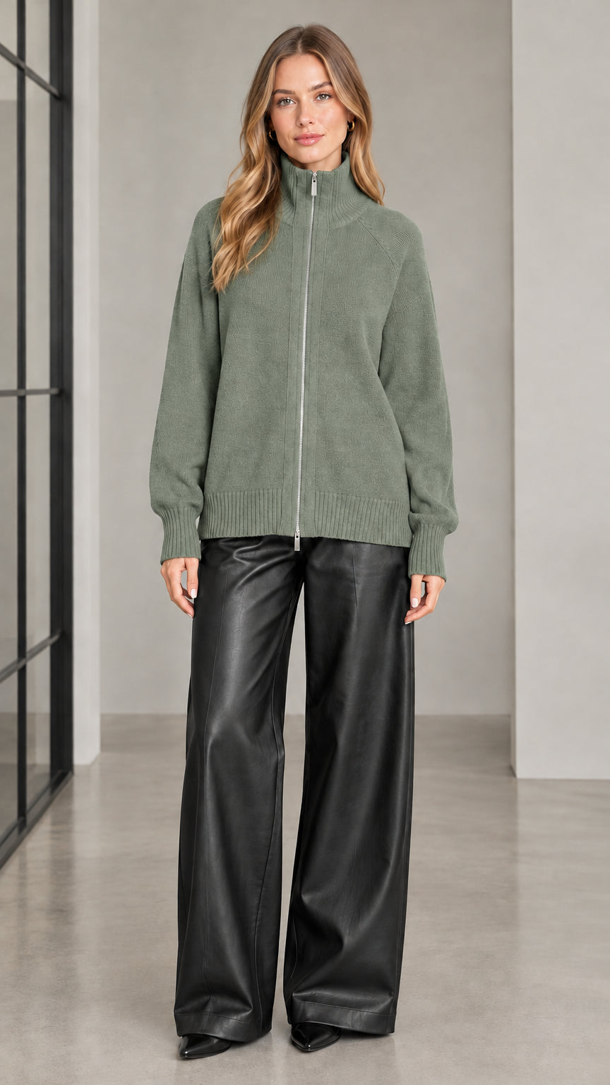 Front view of woman wearing sage green full zip high neck knit sweater