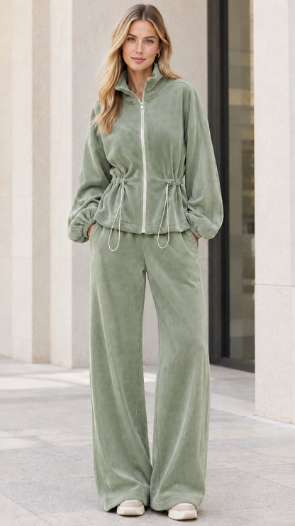 Model wearing sage green ribbed zip-up jacket and wide leg lounge pants set