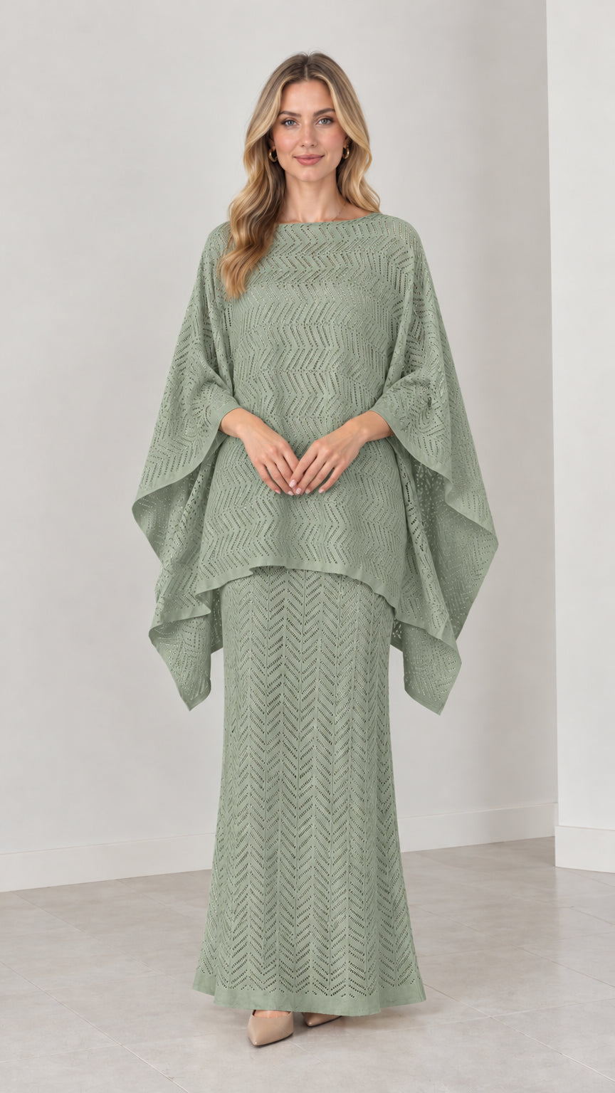 Front view of model wearing sage green pointelle knit cape top and maxi skirt set