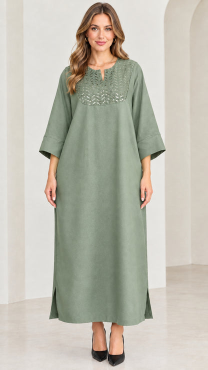 Front view of woman wearing sage green sequin kaftan maxi dress