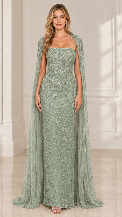 Front view of woman wearing sage green strapless beaded formal gown with cape overlay