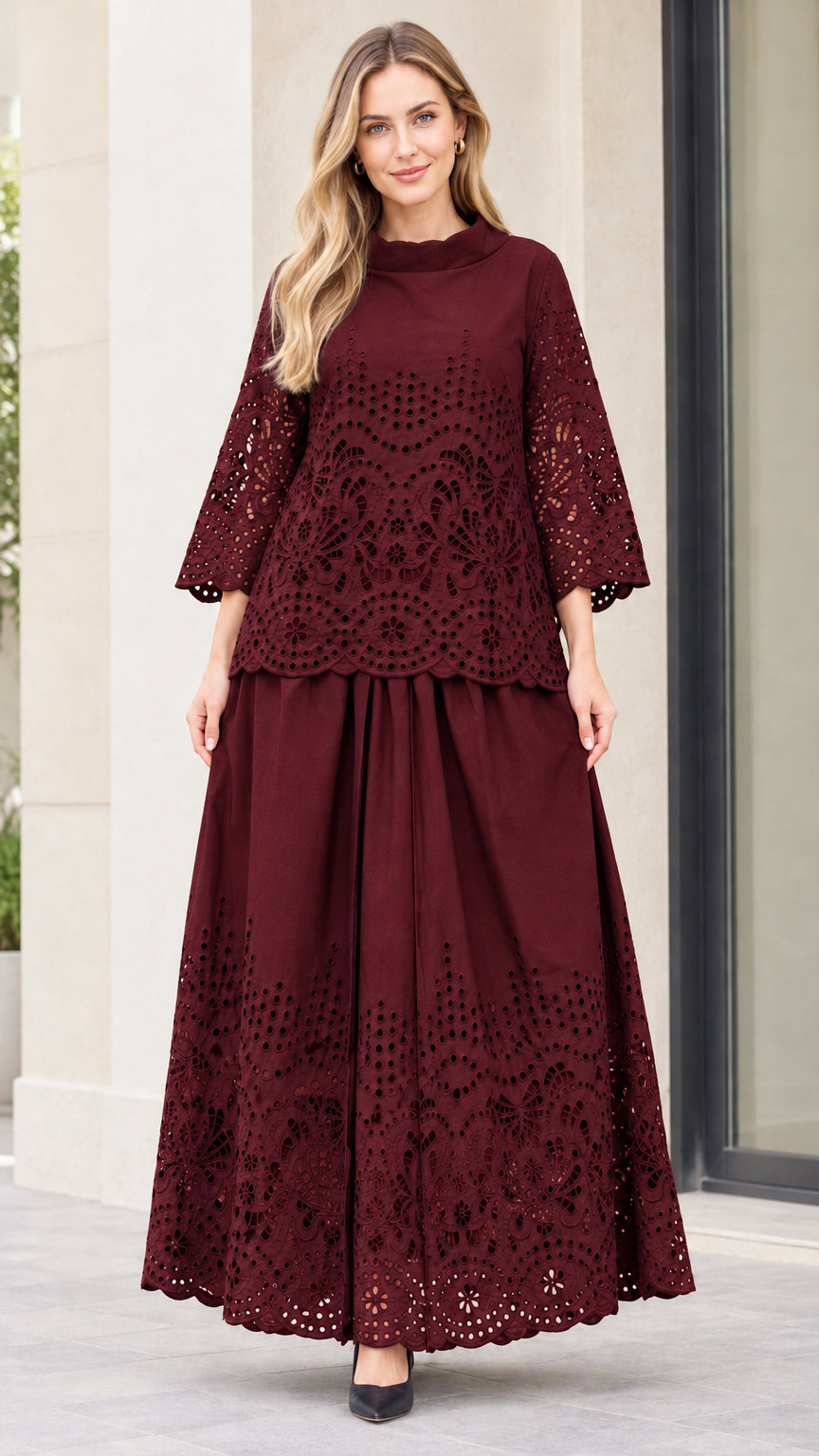 Front view of woman wearing burgundy eyelet embroidered top and maxi skirt two-piece set
