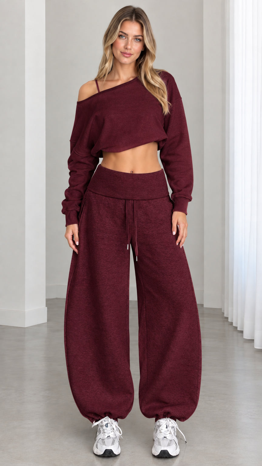 Model wearing rich burgundy wine 2-piece off-shoulder crop top and balloon sweatpants set