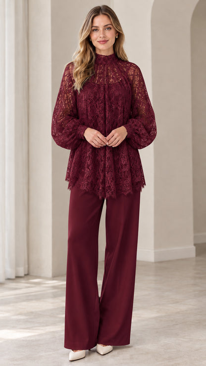 Full look of woman wearing rich burgundy high neck floral lace blouse and matching burgundy wide leg pants