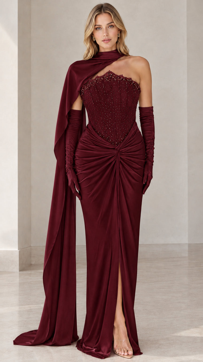 Full-length front view of burgundy embellished corset evening gown with cape and gloves