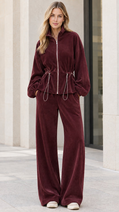 Model wearing burgundy wine red ribbed zip-up jacket and wide leg lounge pants set