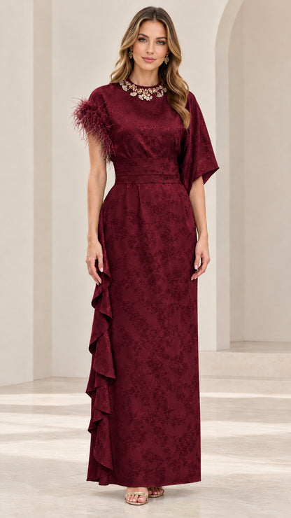 Model wearing rich burgundy embellished jacquard maxi dress with ruffle detailing
