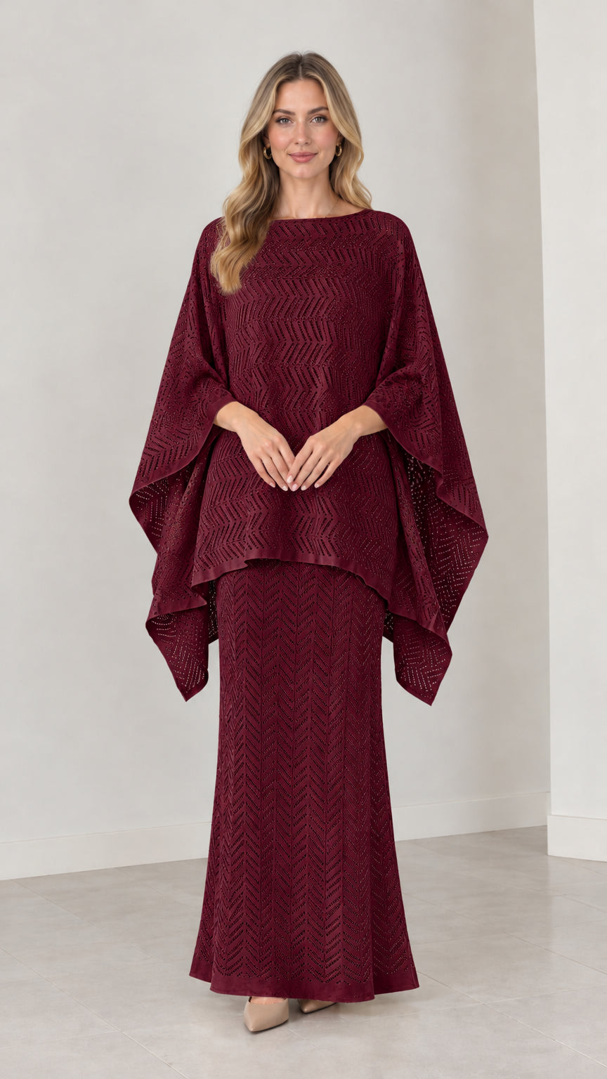 Front view of model wearing burgundy pointelle knit cape top and maxi skirt set