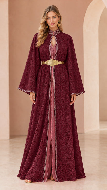 Woman wearing burgundy red floral lace kaftan maxi dress with gold belt