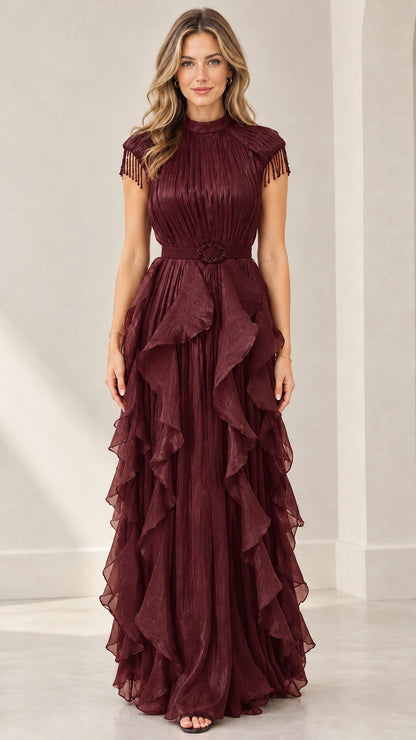 Front view of woman wearing burgundy wine red pleated tiered ruffle evening maxi dress