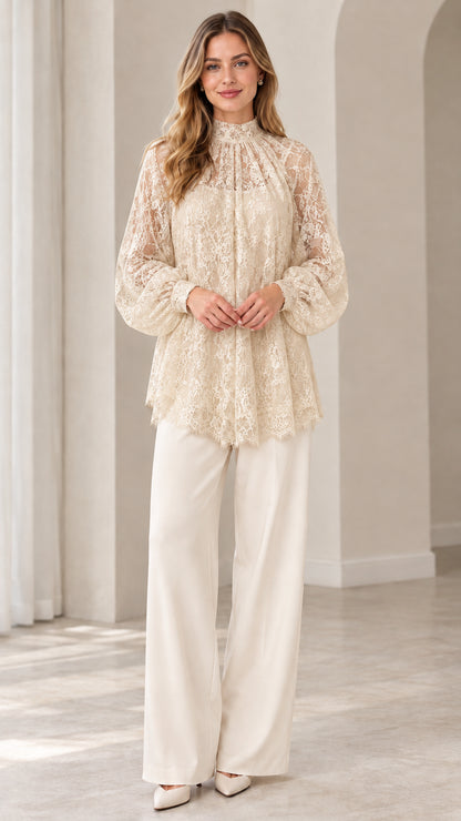 Full look of woman wearing champagne beige floral lace blouse with cream wide leg pants