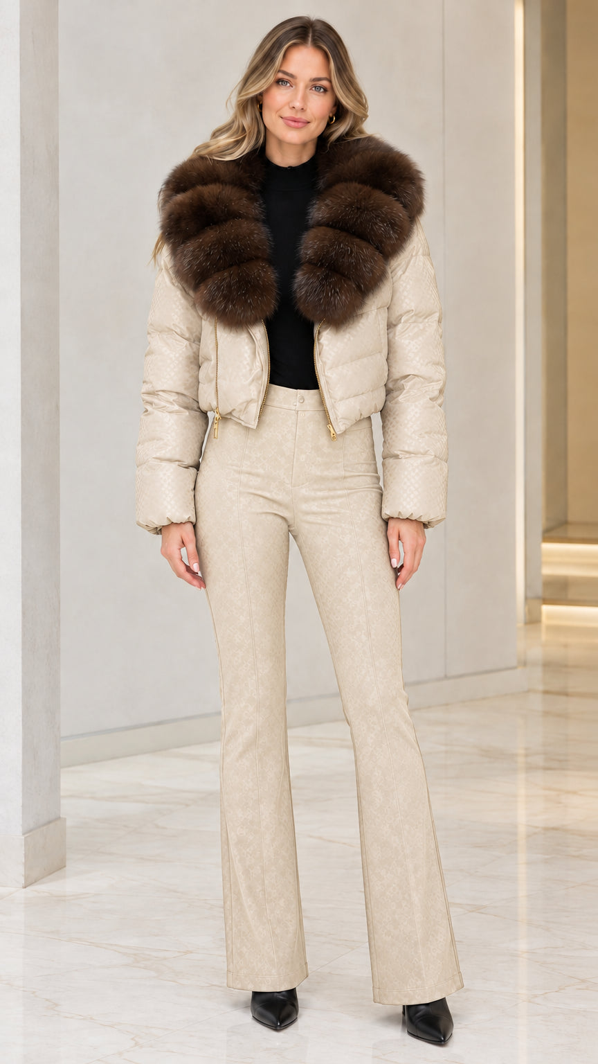Model wearing champagne beige cropped puffer jacket with brown faux fur collar and cream trousers