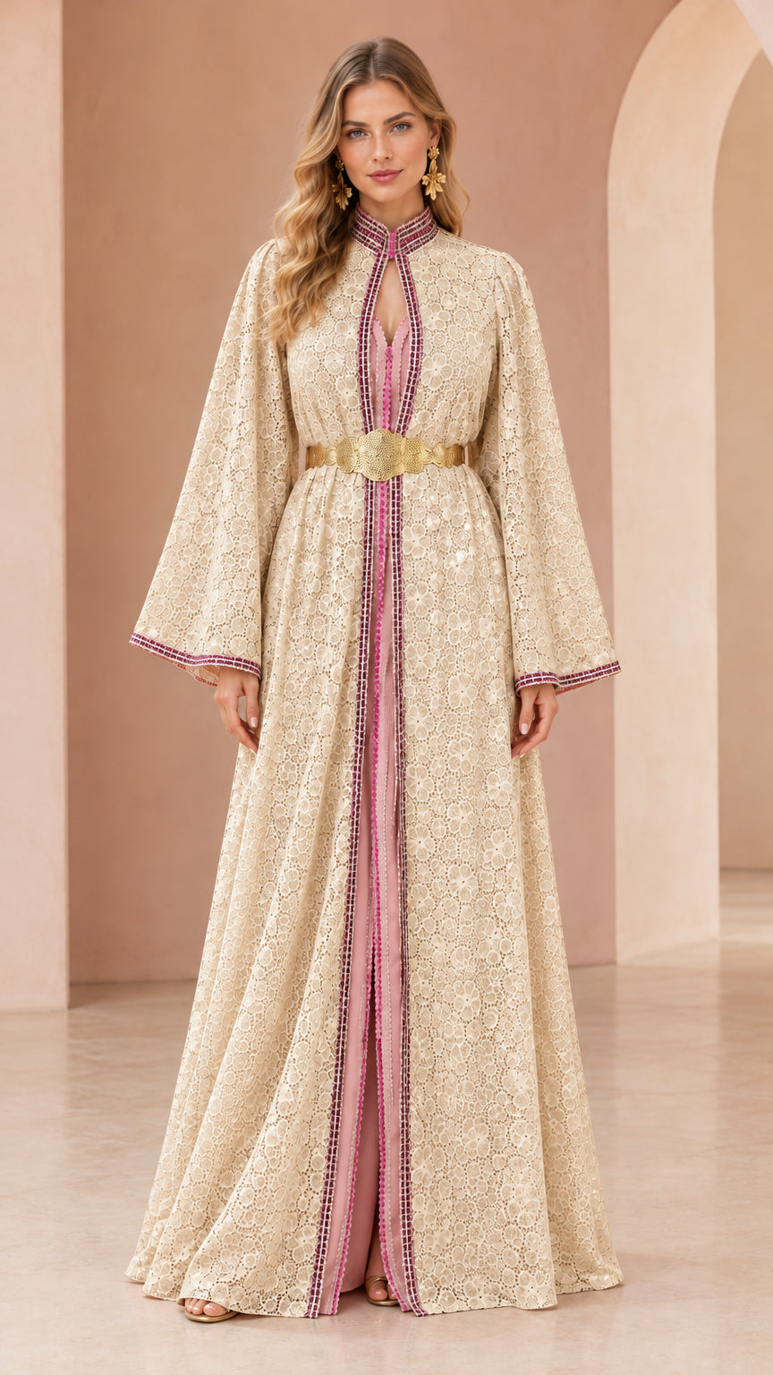 Woman wearing champagne cream floral lace kaftan maxi dress with gold belt