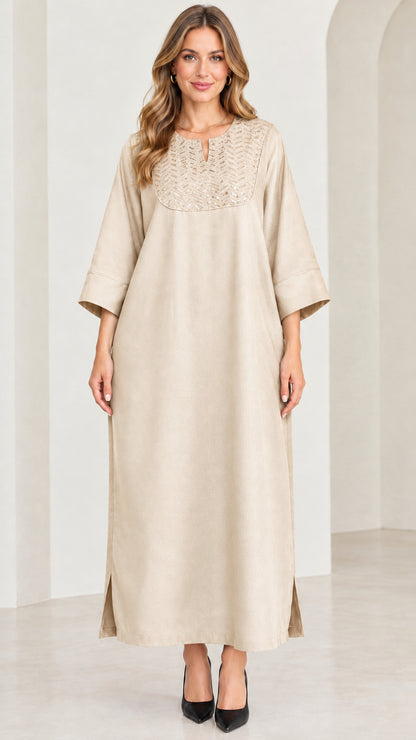 Front view of woman wearing beige champagne sequin kaftan maxi dress