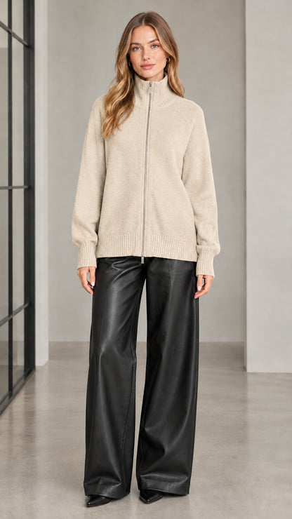 Front view of woman wearing beige full zip knit cardigan sweater