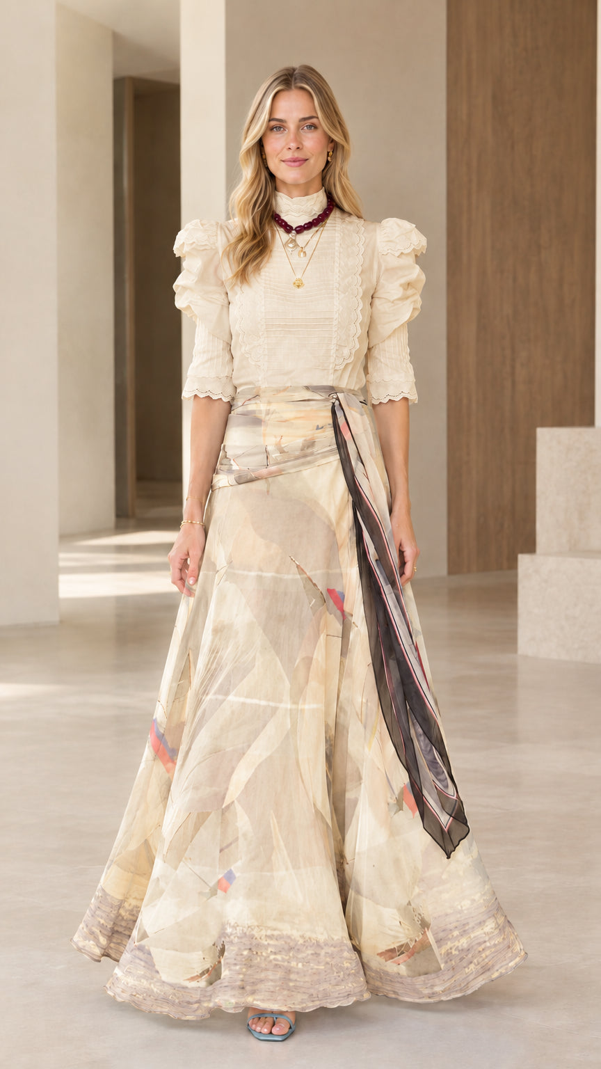 Full-length view of champagne beige mock neck blouse and neutral abstract print maxi skirt